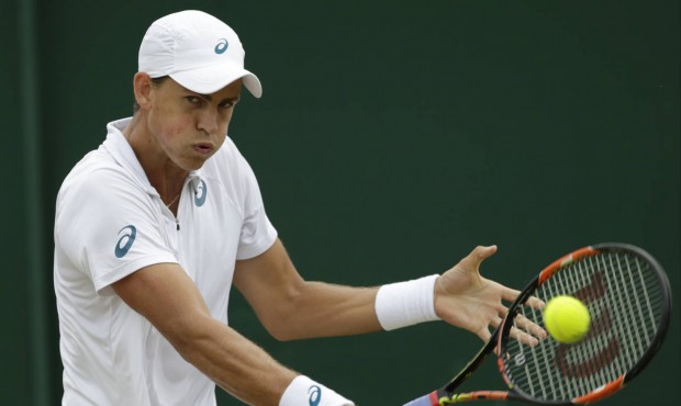 Vasek Pospisil of Canada returns a ball to Viktor Troicki of Serbia during their singles match at t...