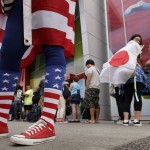 
              A fan of Japan looks at a United States fan as they stand outside BC Place stadium before the FIFA Women's World Cup soccer championship between the U.S. and Japan in Vancouver, British Columbia, Canada, Sunday, July 5, 2015. (AP Photo/Elaine Thompson)
            
