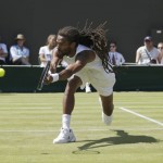 
              Dustin Brown of Germany returns the ball during his singles tennis match against Viktor Troicki of Serbia at the All England Lawn Tennis Championships in Wimbledon, London, Saturday July 4, 2015. (AP Photo/Pavel Golovkin)
            