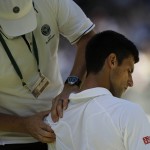 
              Novak Djokovic of Serbia receives treatment on court during the men's singles semifinal match against Richard Gasquet of France at the All England Lawn Tennis Championships in Wimbledon, London, Friday July 10, 2015. (Adrian Dennis/Pool Photo via AP)
            
