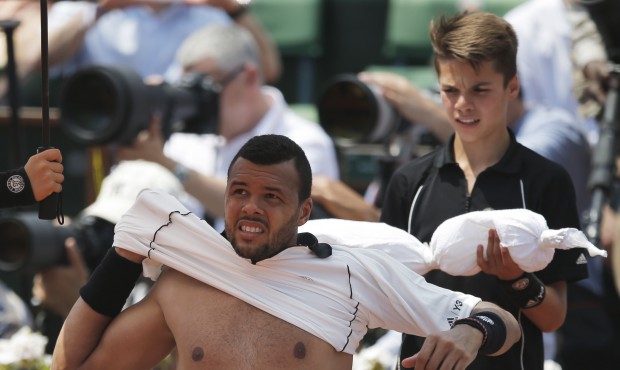 France’s Jo-Wilfried Tsonga changes his jersey during a break as he plays Switzerland’s...