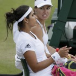 
              Martina Hingis from Switzerland, right, and Sania Mirza from India talk between points during their doubles match against Casey Dellacqua from Australia and Yaroslava Shvedova from Kazakhstan at the All England Lawn Tennis Championships in Wimbledon, London, Wednesday July 8, 2015. (AP Photo/Tim Ireland)
            