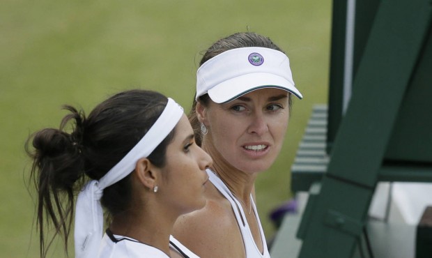 Martina Hingis from Switzerland, right, and Sania Mirza from India talk between points during their...