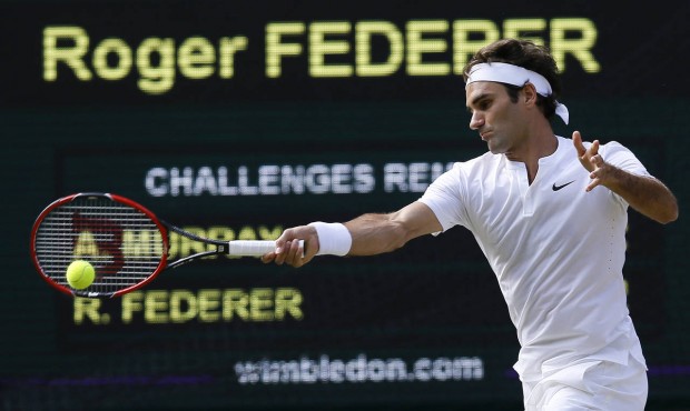 Roger Federer of Switzerland returns a shot to Andy Murray of Britain, during their men’s sin...