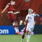 
              Germany's Alexandra Popp heads the ball as United States' Megan Rapinoe (15) defends during the first half of a semifinal in the Women's World Cup soccer tournament, Tuesday, June 30, 2015, in Montreal, Canada. (Ryan Remiorz/The Canadian Press via AP)
            