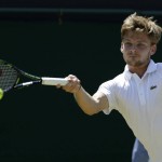 
              David Goffin of Belgium returns a ball to  Marcos Baghdatis of Cyprus, during their singles match at the All England Lawn Tennis Championships in Wimbledon, London, Friday July 3, 2015. (AP Photo/Alastair Grant)
            
