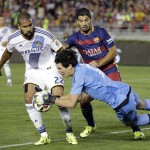 
              Los Angeles Galaxy goalkeeper Brian Rowe, front, makes a save in front of Galaxy's Leonardo, left, and FC Barcelona's Luis Suarez during the first half of an International Champions Cup soccer match Tuesday, July 21, 2015, in Pasadena, Calif. (AP Photo/Jae C. Hong)
            