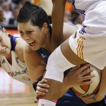 Phoenix Mercury's Diana Taurasi, left, and Briana Gilbreath, right, force a jump ball as Minnesota Lynx's Janel McCarville, center, tries to hang on to the ball during the first half in a WNBA Western Conference Finals basketball game on Sunday, Sept. 29, 2013, in Phoenix. (AP Photo/Ross D. Franklin)