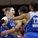 Minnesota Lynx's Lindsay Whalen, left, celebrates a win over the Phoenix Mercury with teammates Monica Wright (22) and Maya Moore as time expires in a WNBA Western Conference Finals basketball game on Sunday, Sept. 29, 2013, in Phoenix. The Lynx defeated the Mercury 72-65, and won the Western Conference Finals 2-0, earning a trip to the WNBA Finals to face the Atlanta Dream. (AP Photo/Ross D. Franklin)