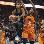 East's Angel McCoughtry, front left, of the Atlanta Dream, goes up for a basket against West's Jantel Lavender, front right, of the Los Angeles Sparks, during the first half of the WNBA All-Star basketball game, Saturday, July 25, 2015, in Uncasville, Conn. (AP Photo/Jessica Hill)
