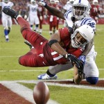 Arizona Cardinals wide receiver Larry Fitzgerald (11) can't make the catch as Indianapolis Colts cornerback Cassius Vaughn (32) defends during the second half of an NFL football game, Sunday, Nov. 24, 2013, in Glendale, Ariz. (AP Photo/Matt York)