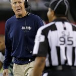 Seattle Seahawks coach Pete Carroll looks at side judge James Coleman (95) during the first half of an NFL football game against the Arizona Cardinals, Thursday, Oct. 17, 2013, in Glendale, Ariz. (AP Photo/Ross D. Franklin)