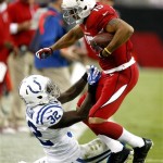 Arizona Cardinals wide receiver Michael Floyd (15) is tackled by Indianapolis Colts cornerback Cassius Vaughn (32) during the first half of an NFL football game, Sunday, Nov. 24, 2013, in Glendale, Ariz. (AP Photo/Rick Scuteri)