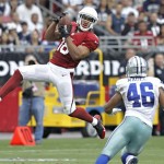 Arizona Cardinals wide receiver Kerry Taylor (18) pulls in a pass as Dallas Cowboys outside linebacker Brandon Magee (46) defends during the first half of a preseason NFL football game on Saturday, Aug. 17, 2013, in Glendale, Ariz. (AP Photo/Rick Scuteri)