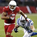 Arizona Cardinals wide receiver Michael Floyd (15) gains yards as Indianapolis Colts inside linebacker Pat Angerer (51) defends during the first half of an NFL football game, Sunday, Nov. 24, 2013, in Glendale, Ariz. (AP Photo/Ross D. Franklin)