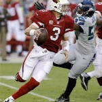 Arizona Cardinals quarterback Carson Palmer (3) scrambles under pressure from Seattle Seahawks defensive end Cliff Avril (56) during the first half of an NFL football game, Thursday, Oct. 17, 2013, in Glendale, Ariz. (AP Photo/Ross D. Franklin)