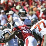 Tampa Bay Buccaneers quarterback Mike Glennon (8) is hit by Arizona Cardinals defensive end Darnell Dockett (90) as he releases the ball during the first quarter of an NFL football game Sunday, Sept. 29, 2013, in Tampa, Fla. (AP Photo/Brian Blanco)
