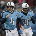 Tennessee Titans running back Chris Johnson (28) and quarterback Ryan Fitzpatrick (4) head to the sideline after Johnson scored a touchdown against the Arizona Cardinals on a 25-yard pass play in the first quarter of an NFL football game Sunday, Dec. 15, 2013, in Nashville, Tenn. (AP Photo/Wade Payne)