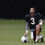Arizona Cardinals' Carson Palmer pauses while stretching out during NFL football training camp at University of Phoenix Stadium on Tuesday, July 30, 2013, in Glendale, Ariz. (AP Photo/Ross D. Franklin)