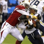 San Diego Chargers running back Ryan Mathews, right, is tackled by Arizona Cardinals defensive end John Abraham, left, during the first half of a preseason NFL football game, Saturday, Aug. 24, 2013, in Glendale, Ariz. (AP Photo/Rick Scuteri)