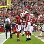 Arizona Cardinals wide receiver Larry Fitzgerald (11) celebrates his touchdown with teammates Andre Roberts (12) and Jaron Brown (13) during the first half of an NFL football game against the Atlanta Falcons, Sunday, Oct. 27, 2013, in Glendale, Ariz. (AP Photo/Rick Scuteri)