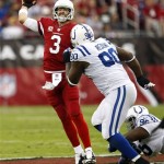 Arizona Cardinals quarterback Carson Palmer (3) throws over Indianapolis Colts defensive end Cory Redding (90) during the first half of an NFL football game, Sunday, Nov. 24, 2013, in Glendale, Ariz. (AP Photo/Rick Scuteri)