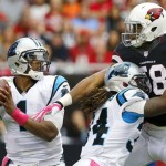 Arizona Cardinals' Daryl Washington, right, gets blocks by Carolina Panthers' DeAngelo Williams, middle, as Panthers quarterback Cam Newton looks to throw the ball in the first half of an NFL football game on Sunday, Oct. 6, 2013, in Glendale, Ariz. (AP Photo/Ross D. Franklin)