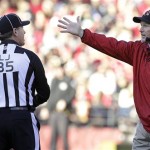 Arizona Cardinals head coach Ken Whisenhunt, right, talks with line judge John Hussey (35) during the second half of an NFL football game against the San Francisco 49ers in San Francisco, Sunday, Dec. 30, 2012. (AP Photo/Tony Avelar)