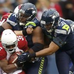 Seattle Seahawks defensive tackle Brandon Mebane (92) and outside linebacker K.J. Wright (50) tackle Arizona Cardinals running back LaRod Stephens-Howling (36) during the first quarter of an NFL football game in Seattle, Sunday, Dec. 9, 2012. (AP Photo/John Froschauer)