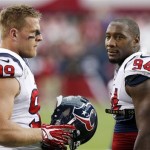 
Houston Texans' J.J. Watt (99) and Antonio Smith (94) stand together as they warm up with their teammates prior to an NFL football game against the Arizona Cardinals on Sunday, Nov. 10, 2013, in Glendale, Ariz. (AP Photo/Ross D. Franklin)