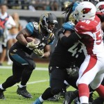 Jacksonville Jaguars running back Maurice Jones-Drew (32) charges past the Arizona Cardinals defense, including linebacker Marcus Benard (59) for a 1-yard touchdown during the first half of an NFL football game in Jacksonville, Fla., Sunday, Nov. 17, 2013. (AP Photo/Stephen Morton)