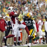 Arizona Cardinals' Andre Roberts can't catch a pass with Green Bay Packers' Jerron McMillian (22) defending during the first half of a preseason NFL football game Friday, Aug. 9, 2013, in Green Bay, Wis. (AP Photo/Mike Roemer)
