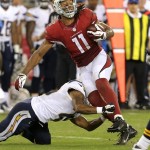 Arizona Cardinals wide receiver Larry Fitzgerald (11) is tackled against the San Diego Chargers during the first half of a preseason NFL football game, Saturday, Aug. 24, 2013, in Glendale, Ariz. (AP Photo/Rick Scuteri)