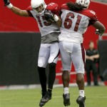 Arizona Cardinals' Michael Floyd (15) celebrates a touchdown with teammate Jonathan Cooper (61) during the Cardinals' Red & White scrimmage at NFL football training campon Saturday, Aug. 3, 2013, in Glendale, Ariz. (AP Photo/Ross D. Franklin)
