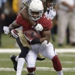Arizona Cardinals running back Andre Ellington (38) is wrapped up by New Orleans Saints cornerback Keenan Lewis (28) in the first half of an NFL football game in New Orleans, Sunday, Sept. 22, 2013. (AP Photo/Bill Feig)