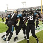 Jacksonville Jaguars quarterback Chad Henne (7) celebrates with tight end Danny Noble (88), Cameron Bradfield (78) and other players after throwing to Noble for a touchdown on a 62-yard play against the Arizona Cardinals during the first half of an NFL football game in Jacksonville, Fla., Sunday, Nov. 17, 2013. (AP Photo/Stephen Morton)