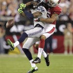 Seattle Seahawks cornerback Richard Sherman (25) breaks up a pass intended for Arizona Cardinals wide receiver Michael Floyd during the first half of an NFL football game, Thursday, Oct. 17, 2013, in Glendale, Ariz. (AP Photo/Rick Scuteri)