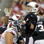 Arizona Cardinals quarterback Carson Palmer, right, throws under pressure against the Houston Texans during the first half of an NFL football game Sunday, Nov. 10, 2013, in Glendale, Ariz. (AP Photo/Rick Scuteri)