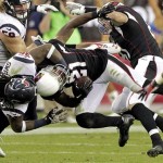 Houston Texans strong safety D.J. Swearinger, second from left, tackles Arizona Cardinals cornerback Patrick Peterson (21) during a punt return in the second half of an NFL football game Sunday, Nov. 10, 2013, in Glendale, Ariz. (AP Photo/Rick Scuteri)