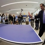 New Jersey Gov. Chris Christie plays ping pong at an NFL Foundation event Monday, Jan 27, 2014, in Newark, N.J. (AP Photo/Charlie Riedel)