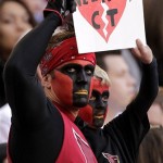 Arizona Cardinals fans hold a sign in memory of the victims of Friday's Sandy Hook Elementary School shootings during the first half of an NFL football game between the Arizona Cardinals and the Detroit Lions, Sunday, Dec. 16, 2012, in Glendale, Ariz. (AP Photo/Matt York)