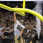 New Orleans Saints tight end Jimmy Graham (80) slam dunks over the goalpost after scoring on a touchdown reception in the second half of an NFL football game against the Arizona Cardinals in New Orleans, Sunday, Sept. 22, 2013. (AP Photo/Bill Haber)