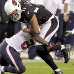 Arizona Cardinals wide receiver Larry Fitzgerald (11) is tackled by Houston Texans cornerback Johnathan Joseph during the second half of an NFL football game Sunday, Nov. 10, 2013, in Glendale, Ariz. (AP Photo/Rick Scuteri)