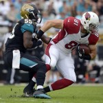 Arizona Cardinals tight end Jim Dray (81) is tackled by Jacksonville Jaguars outside linebacker Geno Hayes (55) after a reception during the first half of an NFL football game in Jacksonville, Fla., Sunday, Nov. 17, 2013. (AP Photo/Phelan M. Ebenhack)