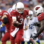 Arizona Cardinals quarterback Carson Palmer (3) hands off to Rashard Mendenhall (28) during the first half of an NFL football game against the Indianapolis Colts, Sunday, Nov. 24, 2013, in Glendale, Ariz. (AP Photo/Matt York)