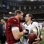 New Orleans Saints quarterback Drew Brees (9) shakes hands with Arizona Cardinals quarterback Carson Palmer, left, after an NFL football game in New Orleans, Sunday, Sept. 22, 2013. The Saints won 31-7. (AP Photo/Bill Haber)