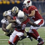 Arizona Cardinals running back Rashard Mendenhall (28) is tackled by New Orleans Saints strong safety Kenny Vaccaro (32) and middle linebacker Curtis Lofton (50) in the first half of an NFL football game in New Orleans, Sunday, Sept. 22, 2013. (AP Photo/Gerald Herbert)