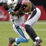 Arizona Cardinals wide receiver Michael Floyd, right, is tackled by Carolina Panthers strong safety Robert Lester during the second half of a NFL football game, Sunday, Oct. 6, 2013, in Glendale, Ariz. (AP Photo/Rick Scuteri)