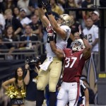 New Orleans Saints tight end Jimmy Graham (80) pulls in a touchdown reception over Arizona Cardinals strong safety Yeremiah Bell (37) in the first half of an NFL football game in New Orleans, Sunday, Sept. 22, 2013. (AP Photo/Bill Feig)