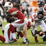 Arizona Cardinals running back Andre Ellington, left, breaks free for a touchdown as Atlanta Falcons outside linebacker Paul Worrilow (55) defends during the first half of an NFL football game Sunday, Oct. 27, 2013, in Glendale, Ariz. (AP Photo/Rick Scuteri)